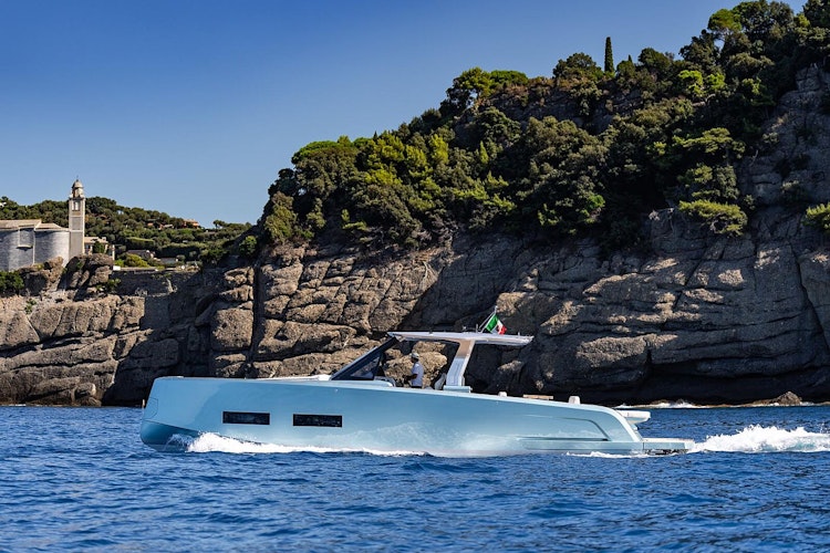 luxurious yacht cruising by cliffs