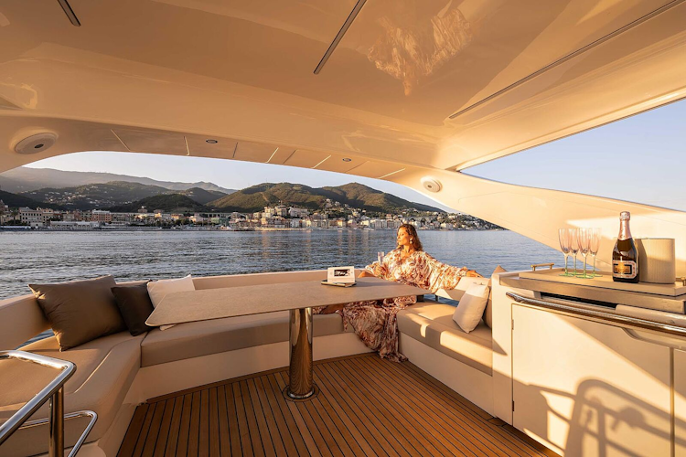 woman enjoying the view from the flybridge dining area - navetta 50