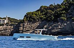 luxurious yacht cruising by cliffs