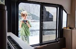 boy with camera looking in window of prestige f4