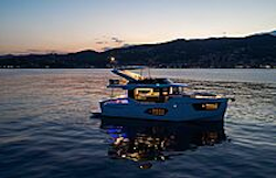 Navetta 50 at sunset with inside lights on