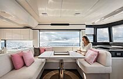 woman reading at dining table of navetta 50